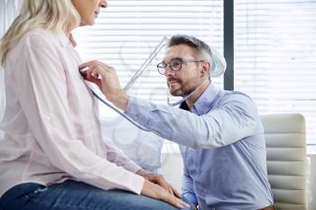 Mature Female Patient Having Medical Exam With Doctor In Office