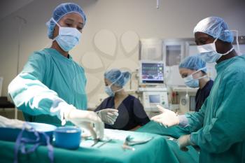 Surgical Team Working On Patient In Hospital Operating Theatre