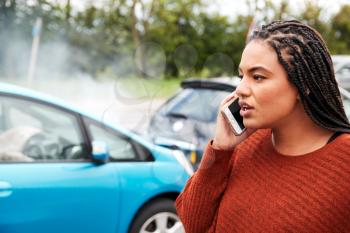 Female Motorist Involved In Car Accident Calling Insurance Company Or Recovery Service