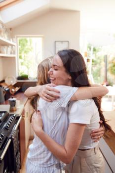 Loving Female Gay Couple Hugging At Home In Kitchen