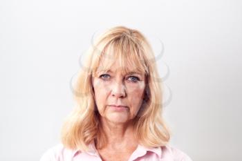 Studio Shot Of Unhappy And Frustrated Mature Woman Against White Background At Camera