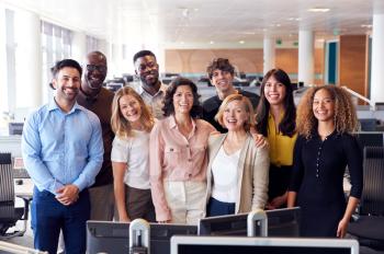 Portrait Of Smiling Business Team Working In Modern Office Together