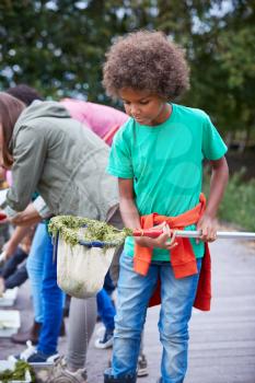 Adult Team Leader Shows Group Of Children On Outdoor Activity Camp How To Catch And Study Pond Life