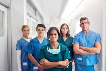 Portrait Of Multi-Cultural Medical Team Standing In Hospital Corridor