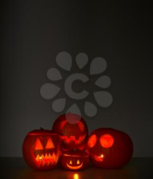 Halloween Still Life Composed Of Carved Pumpkin Jack O'Lanterns Illuminated With Candles
