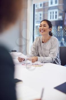 Smiling Asian Businesswoman Sitting At Table In Office  Meeting Room
