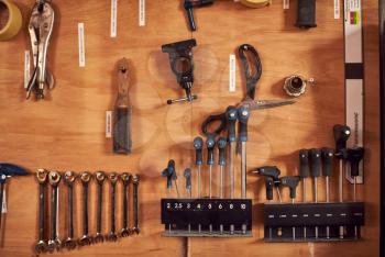 Close Up Of Carpentry Tools Hanging In Workshop Cabinet
