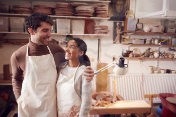 Couple Running Bespoke Pottery Business Working In Ceramics Studio Together