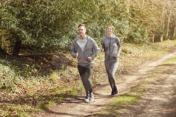 Couple Exercising In Autumn Countryside During Covid 19 Lockdown