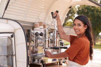 Portrait Of Woman Running Independent Mobile Coffee Shop Making Drink Standing Outdoors Next To Van