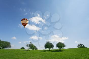 Royalty Free Photo of a Hot Air Balloon Over a Field