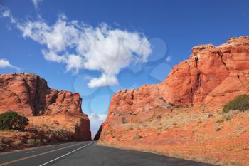 Magnificent American road among rocks of red sandstone