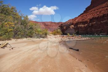 Wild River Colorado. The sandy beach and the steep slope of red sandstone