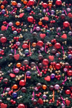 The golden balls and heart hang on ribbons. A perfect christmas background!