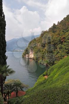 Lake Como in the misty haze. Magnificent park on the shore - Villa Balbianella