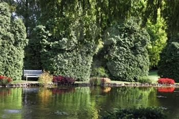 Sigurta charmingly picturesque garden. Shallow pond, and elegantly trimmed trees. Northern Italy