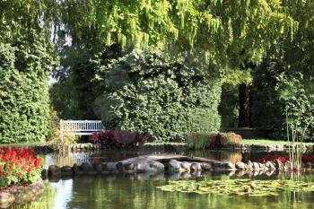 Sigurta charmingly picturesque garden. Shallow pond, and elegantly trimmed trees. Northern Italy