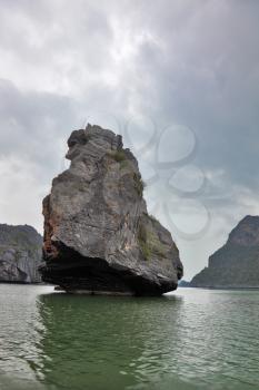 Foggy morning after a storm. The well-known island-rock Monkey Sawasdee Island in the Thai gulf