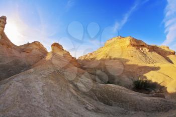 Hills of soft picturesque forms from sandstone on a sunset 