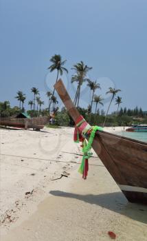 Boat Longtail decorated with silk tapes expects tourists. Island Phi-Phi, Thailand