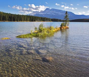 Small charming island in cold Canadian lake