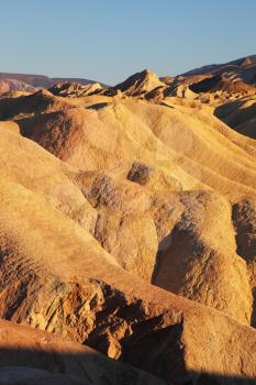 Colorful soft waves of colored sandstone. Death Valley, Zabriskie - Point at sunset