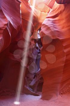 Noon in Antelope Canyon. A thin ray of sunlight illuminates the sandy bottom of the canyon