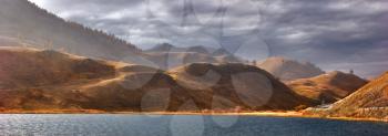 
Lake in Switzerland, surrounded by hills, in autumn day
