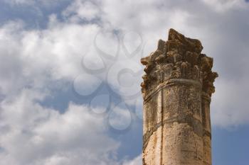  A high harmonous column in ancient port Caesaria on a background of the cloudy sky
