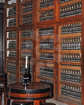 Wooden shelves with bottles of wine. Storage space for an expensive aged wines - Madeira.