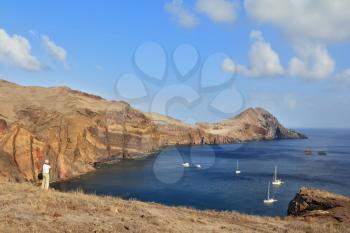 The photographer photographs the white yachts in the picturesque bay. Eastern end of the oceanic island of Madeira