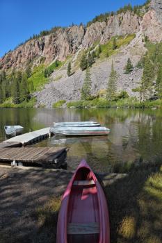 Small red boat on a quiet mountain Mammoth lake