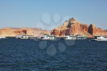 Many tourist boats sailing in the stormy waters of Lake Powell