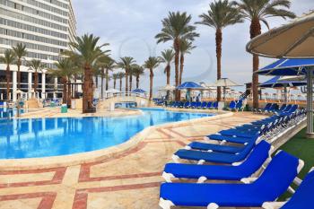Winter in the Dead Sea. The picturesque pool and a comfortable high-rise hotel