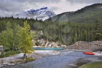  Red boats of a kayak on coast of the mountain river in Canada