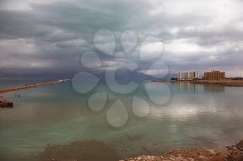 Magical winter sunset at the Dead Sea. The storm and the sun
