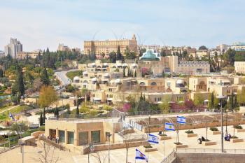 View of the New Jerusalem - modern buildings and people walking.  Walk along the walls of ancient Jerusalem. 