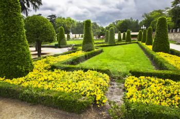 Freakish trees, flower beds and footpaths in park Buen-Retiro