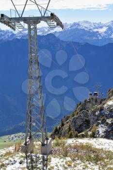 Swiss Alps. Walking around the resort town of Leysin. Metal poles ski lift