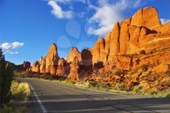 Magnificent road among freakish natural stone formations in the well-known park in the USA arch