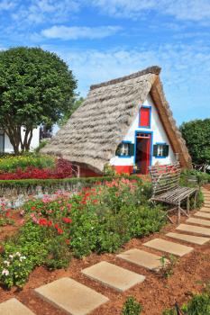 Picturesque house-museum of the first colonists to Madeira. Charming white cottage with a thatched roof and gable small garden with flowers