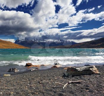 The strong wind blows high waves on Lake Laguna Azul. Patagonia, Chile. Storm begins