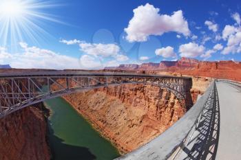 The famous double Navajo Bridge over the River Colorado separately for transport and for pedestrians. The sun is shining on a lovely autumn day
