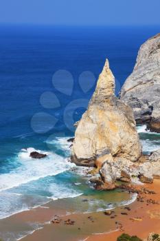 Bizarre sandstone rock on the small beach in Sintra. Portuguese Atlantic coast