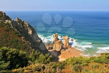 Picturesque rocks on a lonely beach of Atlantic ocean. Coast of Portugal, Cabo da Roca - the most western point of Europe
