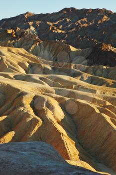 Picturesque soft waves from multi-coloured sandstone. Death valley, Zabriski - a point on a sunset