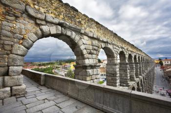 The well-known antique aqueduct and ancient Segovia in cloudy May day