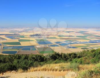 Picturesque squares colored fields of the valley of Galilee. Photographed from Mount Barkan