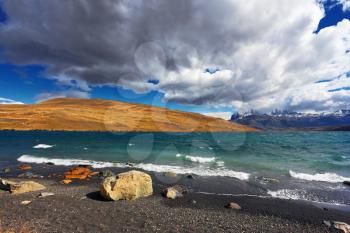  National Park Torres del Paine. Patagonia, Chile. Stormy wind blows high waves on Lake Laguna Azul.  The sharp strong wind drives the waves with white foam