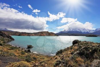 Magic turquoise lake Pehoe national park Torres del Paine, Chile. Majestic rocks Los Kuernos on the bank of the lake are covered with glaciers